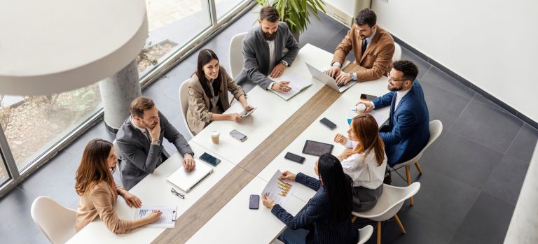 Overhead view of a team meeting at a boardroom table