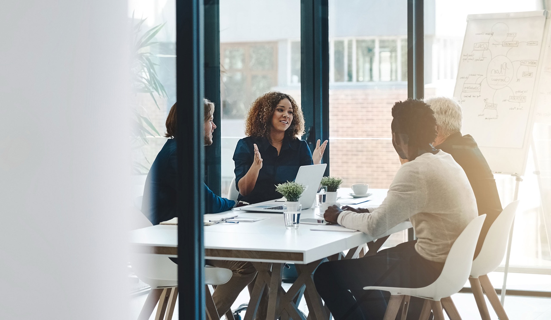 Facilitator leading a discussion at a conference table